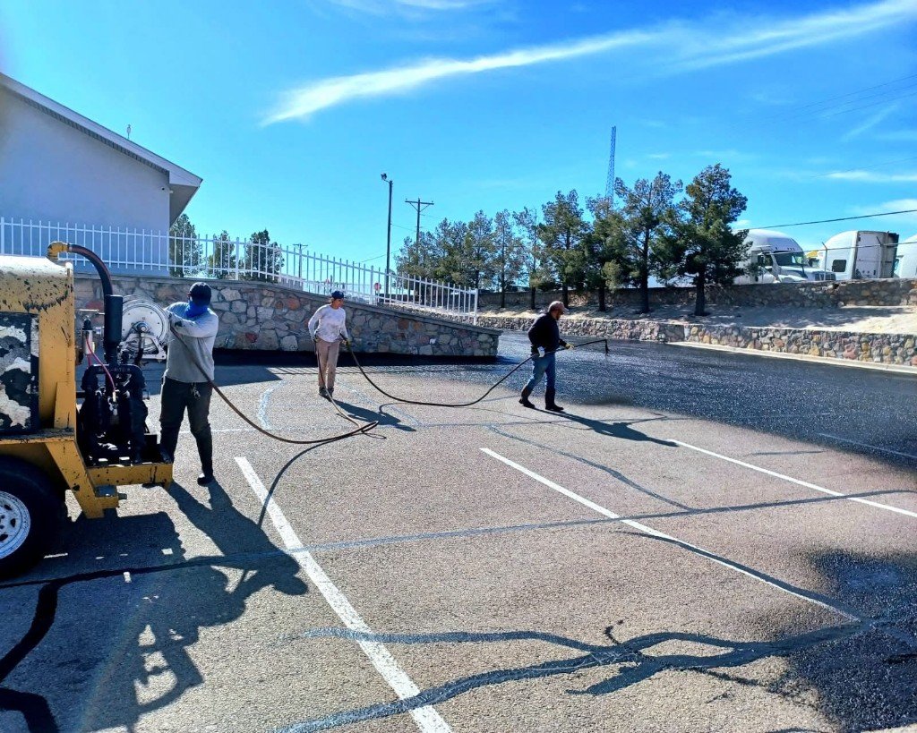 Crew sealcoating a commercial parking lot